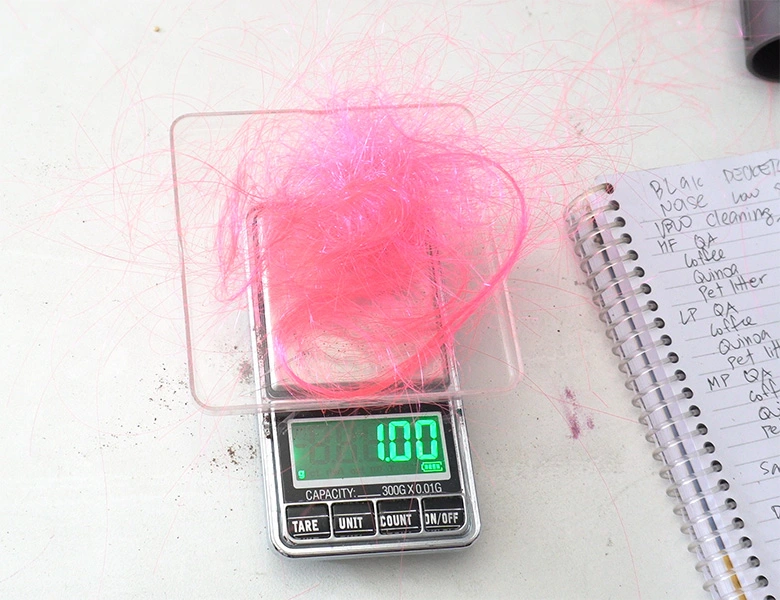 Weighing hair from the dustbin after the test